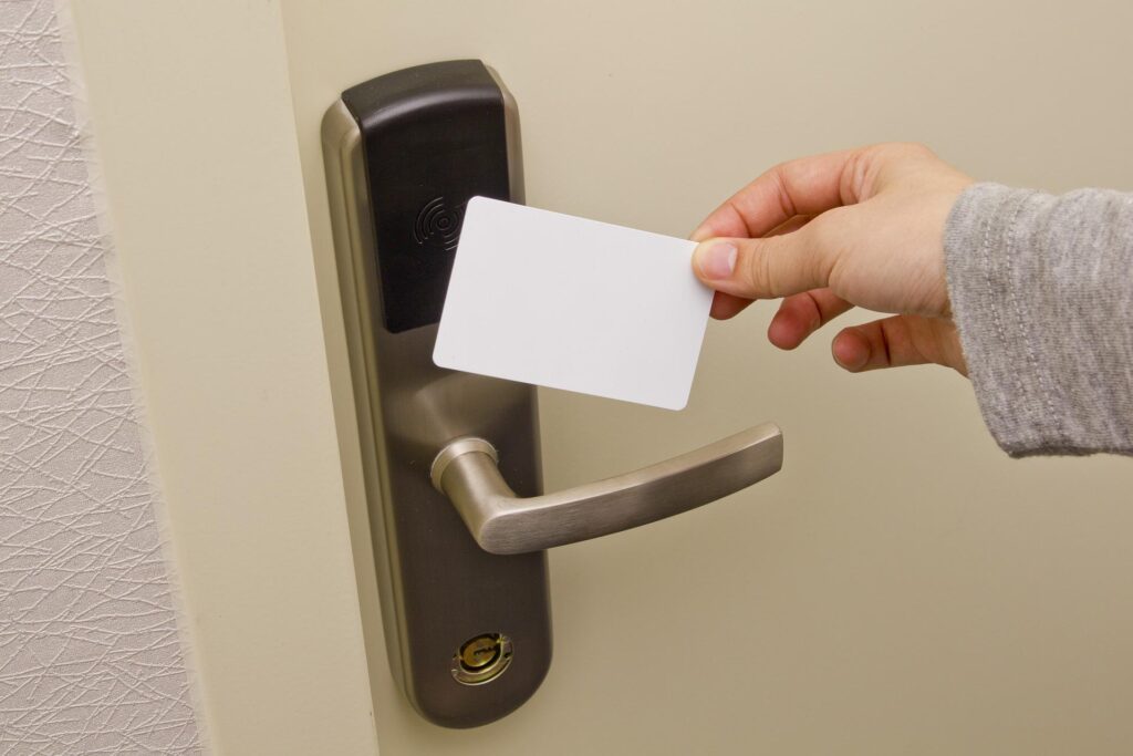 A person placing their access card to a door in a hotel room