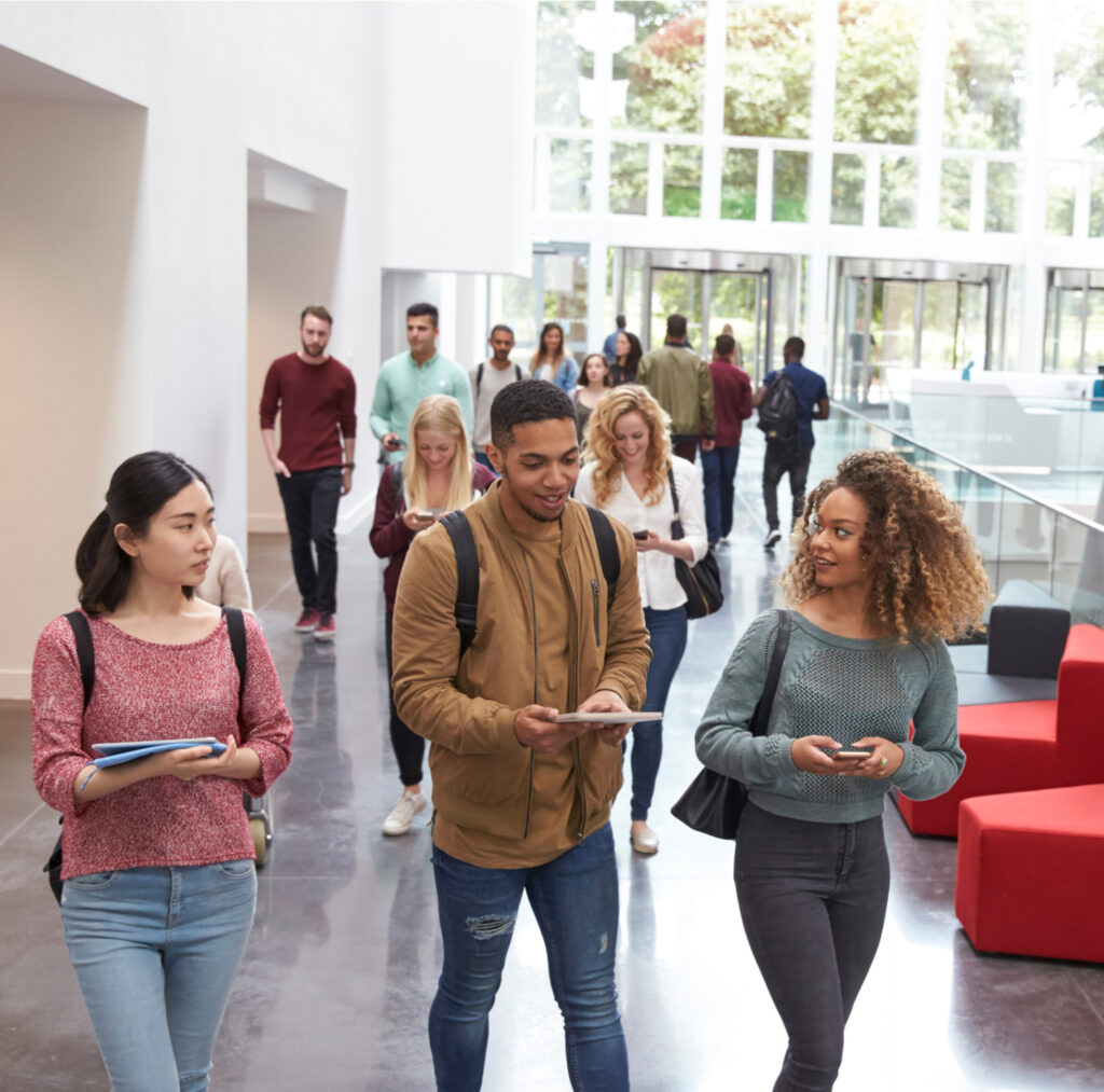 students walking in higher education building