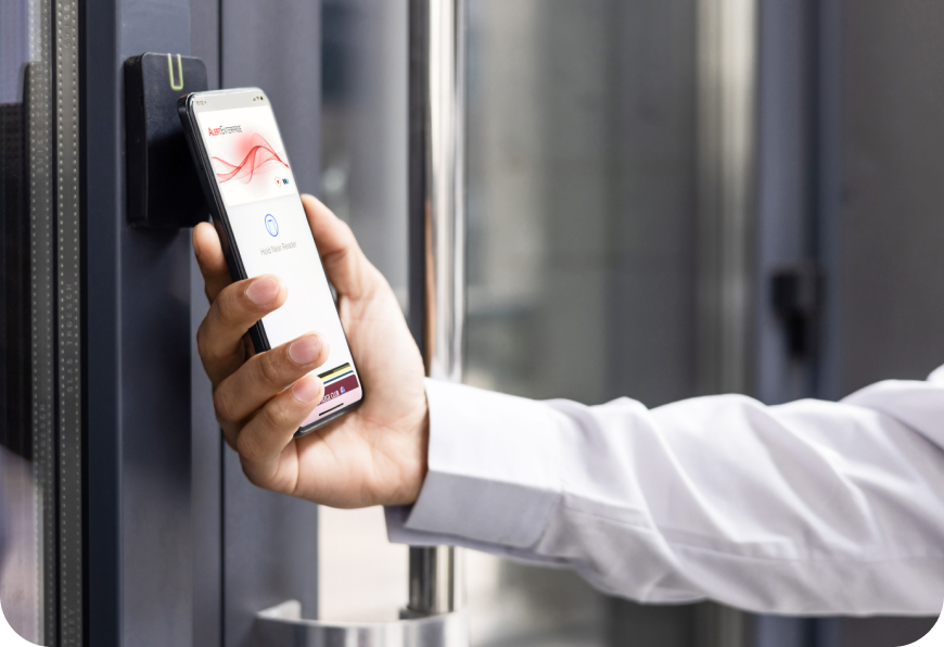 Person using a smartphone with a digital key app to unlock a door.