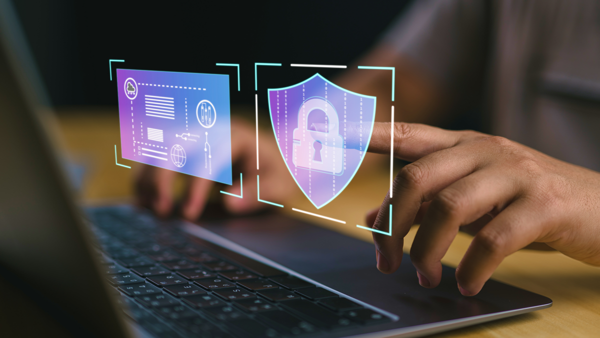 Hands typing on a laptop with floating digital security icons, including a shield and padlock, symbolizing cybersecurity.