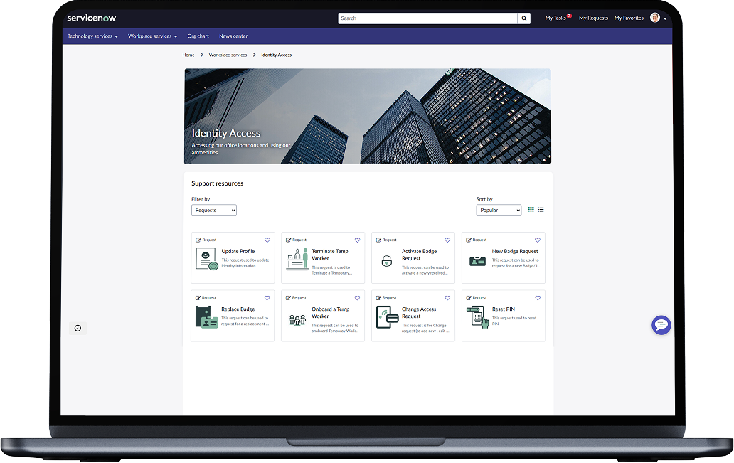 A laptop screen displays a digital dashboard for identity access management, featuring various support resource tiles against a city skyscraper background.