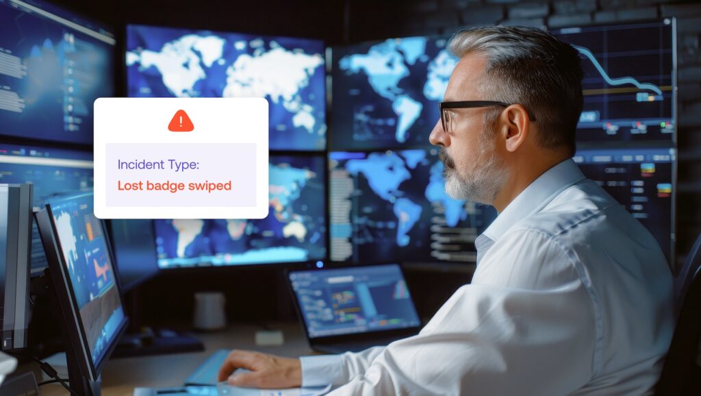 A man working at a computer monitors multiple screens displaying maps, with a pop-up alert reading Incident Type: Lost badge swiped.